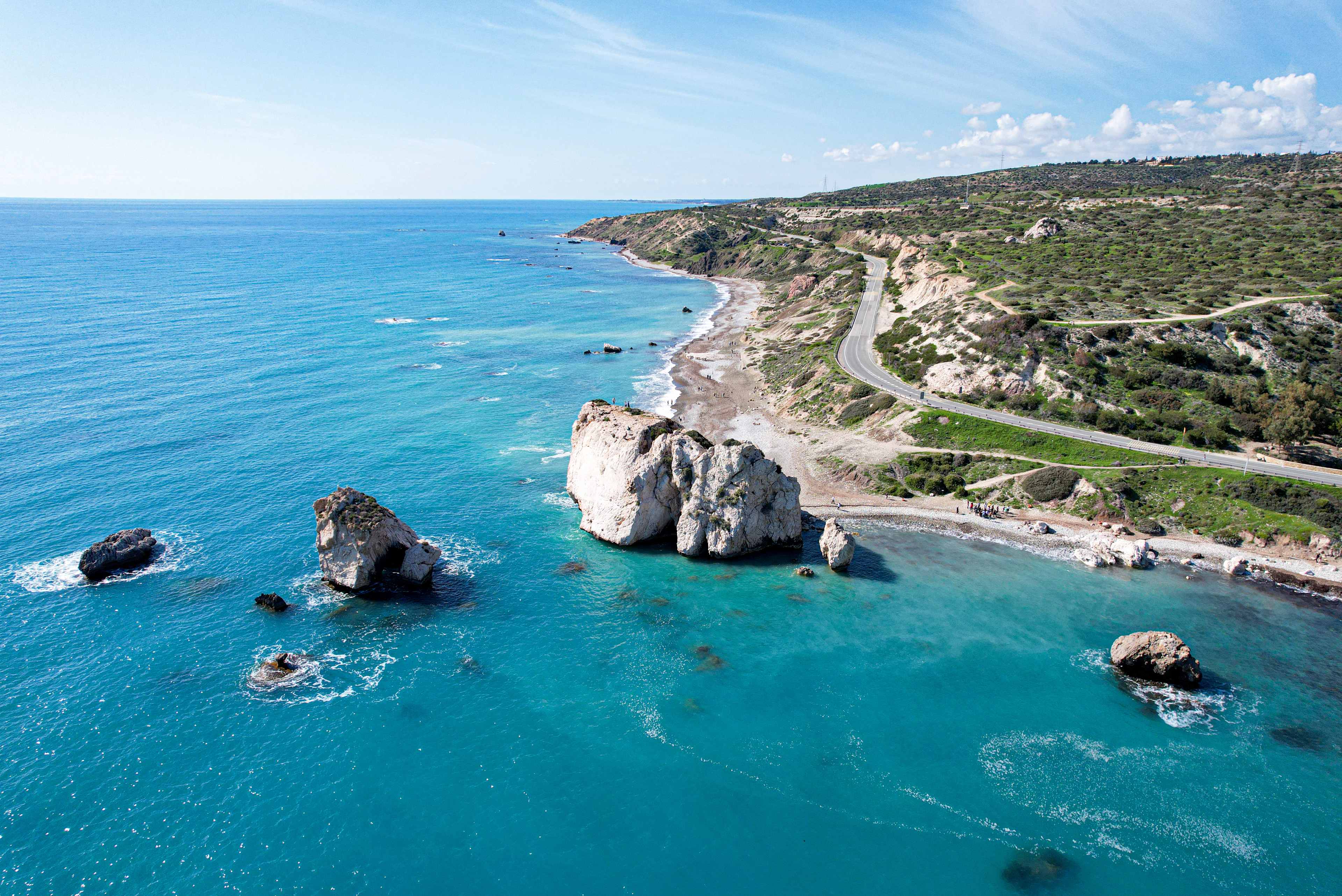 The Cyprus coast near Paphos from the air, sea stacks standing off a curving pebble bay