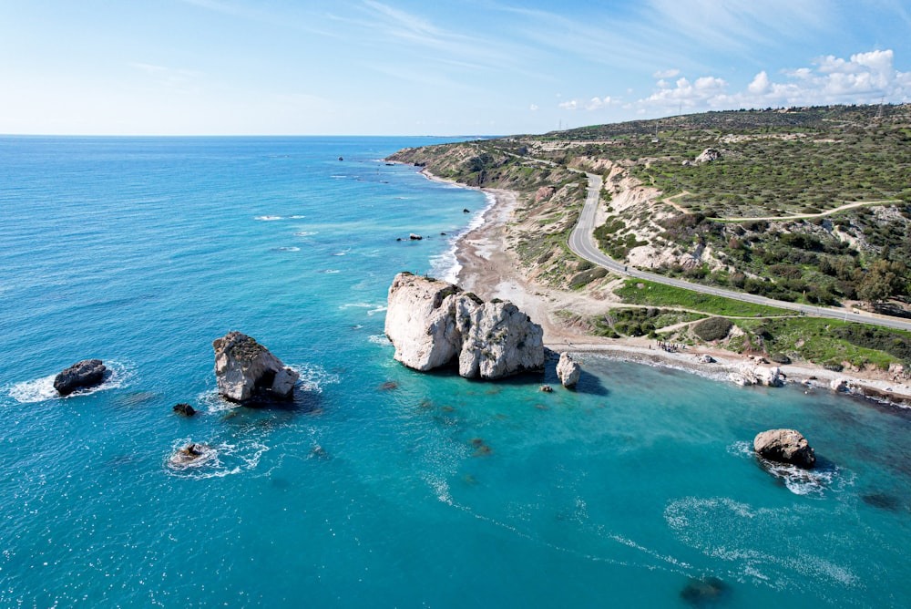 an aerial view of a beach and a road