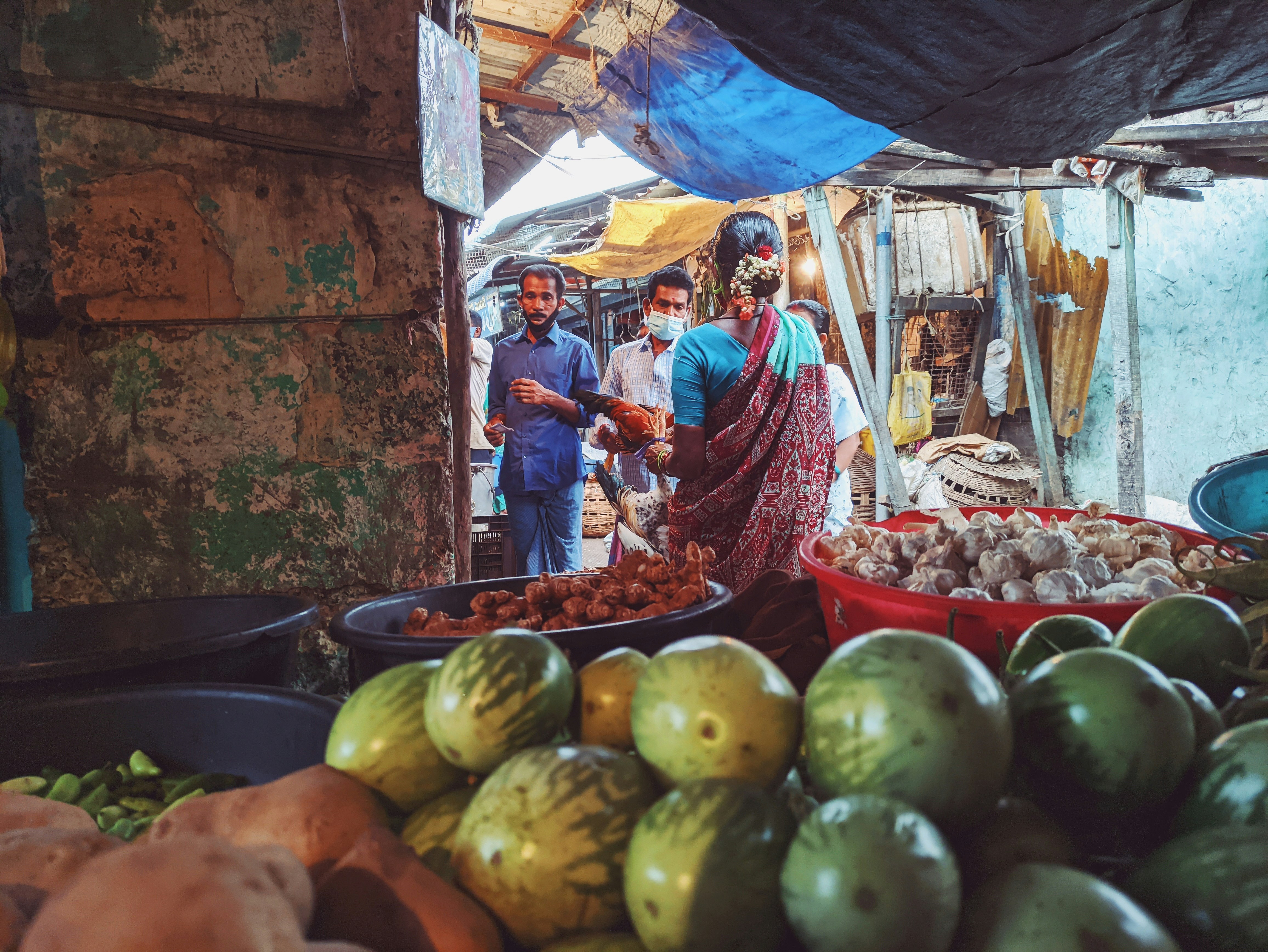 Happy Indian family at a fruit market, warm natural light, colorful fruits in background, joyful atmosphere
