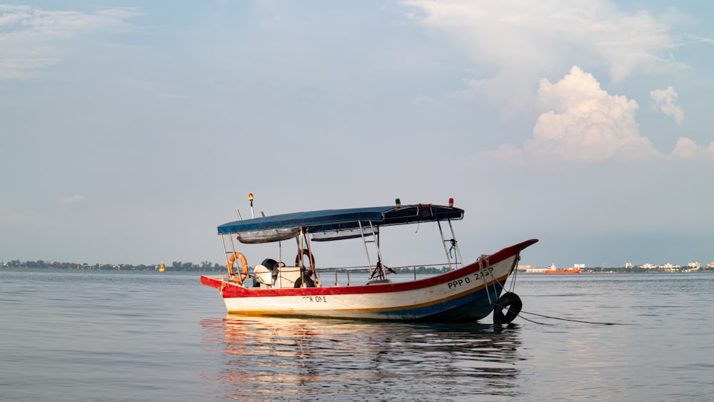 a boat with people on it floating in the water