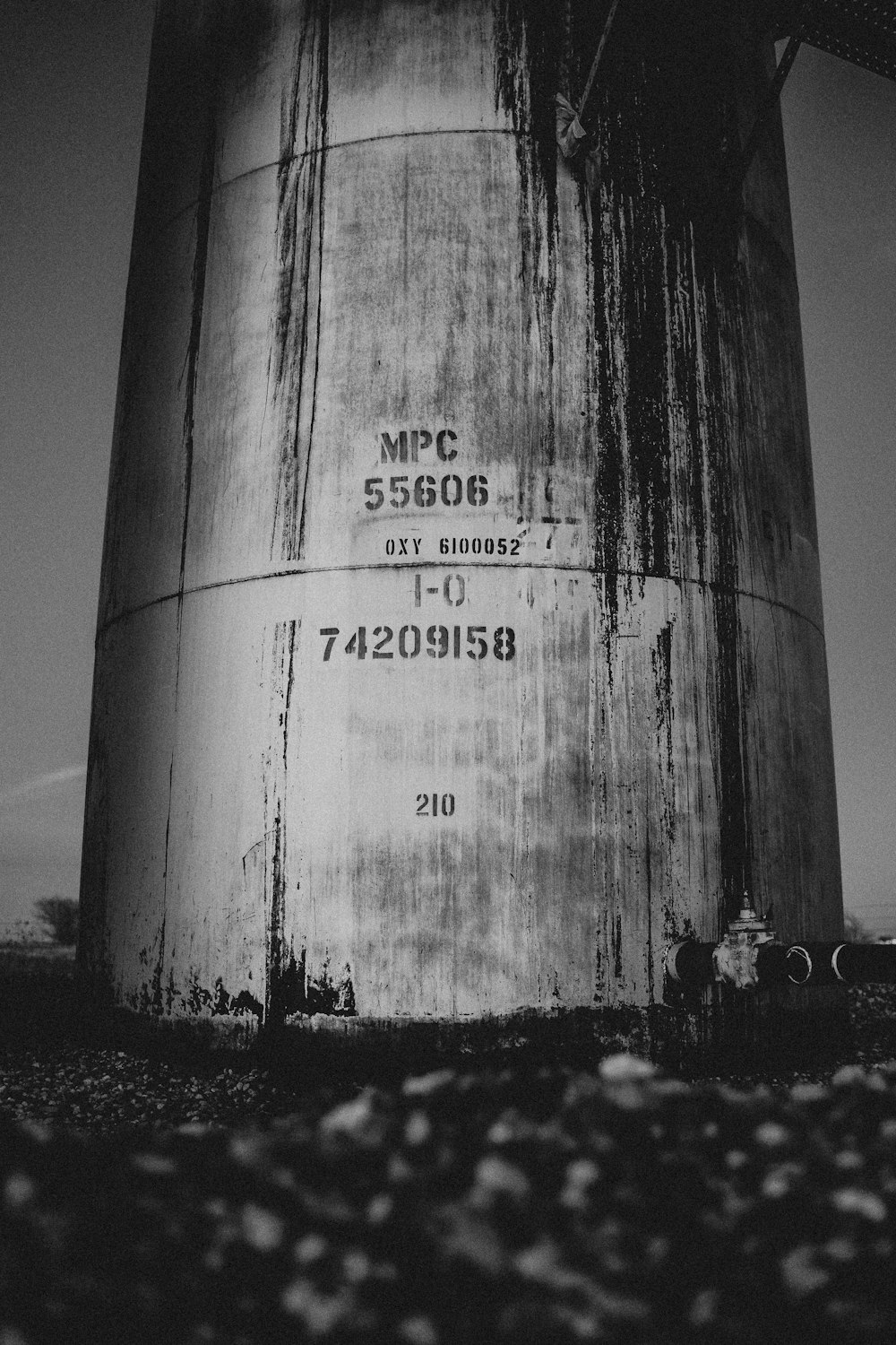 a large water tank sitting in the middle of a field
