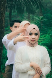 a couple of people that are standing in the woods