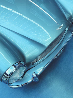 Side profile of a classic used car with polished chrome details.