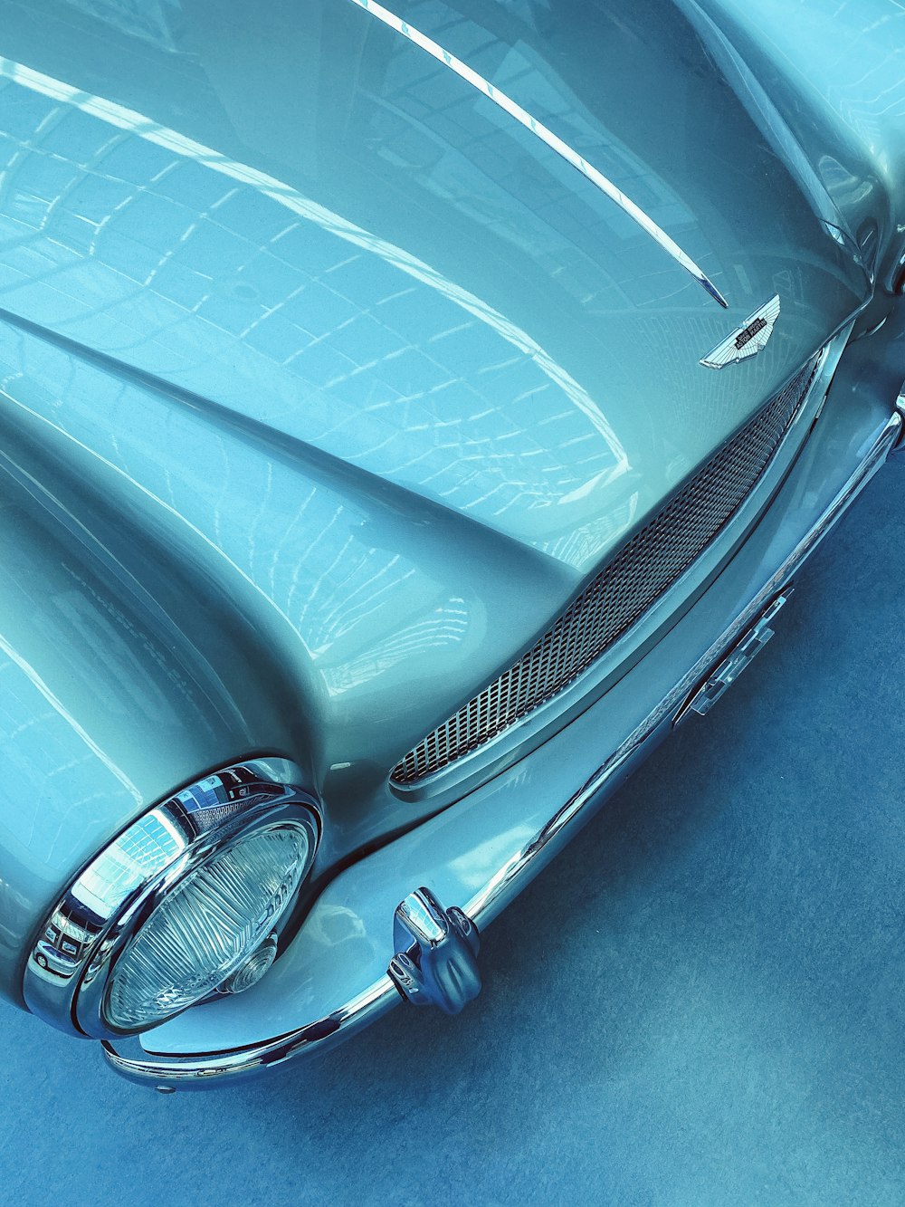 a blue classic car is shown from above
