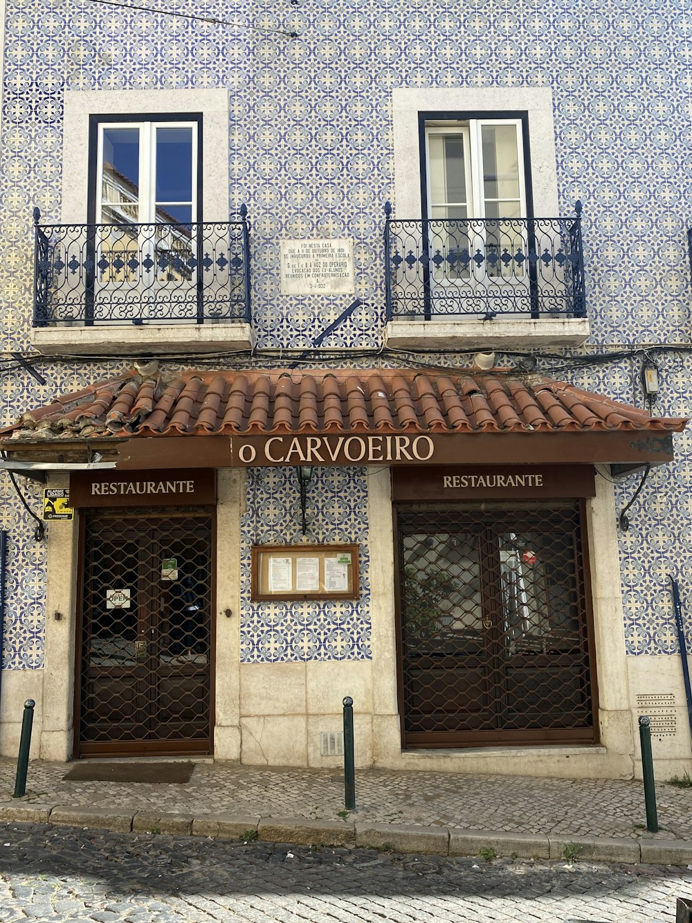 a blue and white building with a red tiled roof