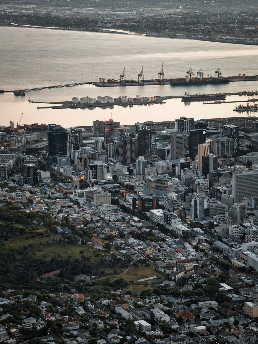 an aerial view of a city and a body of water