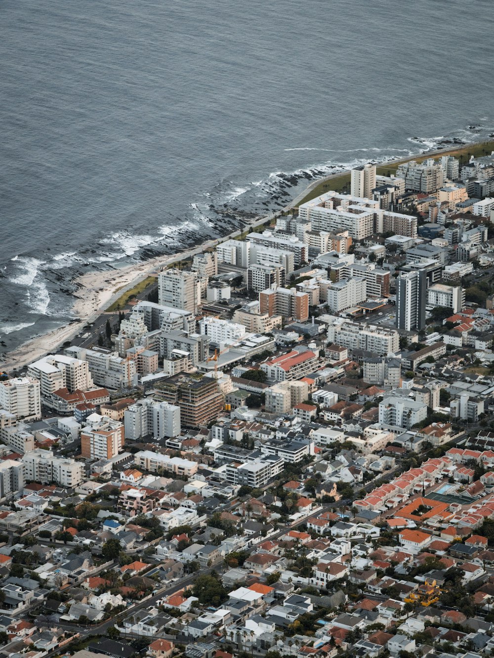 an aerial view of a city by the ocean