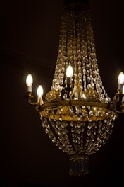 a chandelier hanging from a ceiling in a dark room