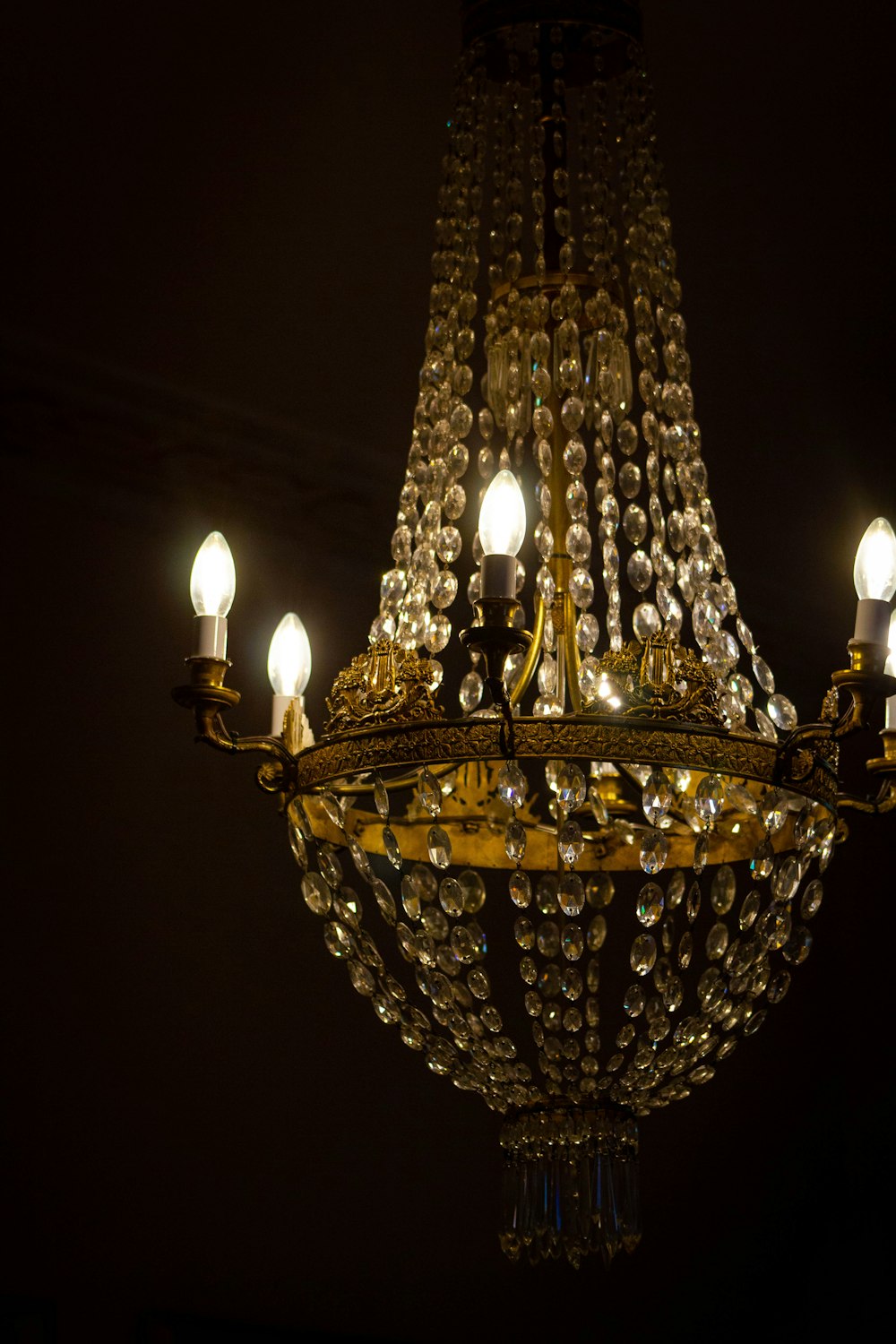 a chandelier hanging from a ceiling in a dark room