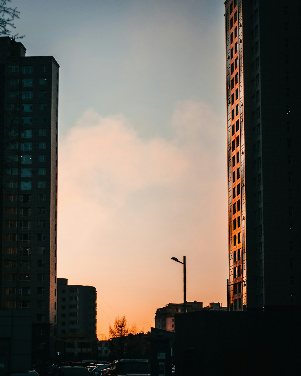 a couple of tall buildings sitting next to each other