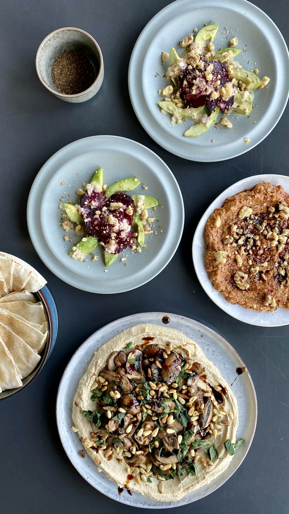 a table topped with three plates of food