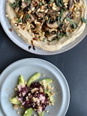 two plates of food on a table next to each other