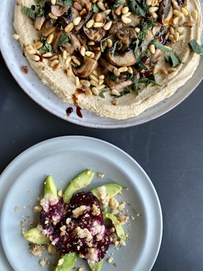 two plates of food on a table next to each other