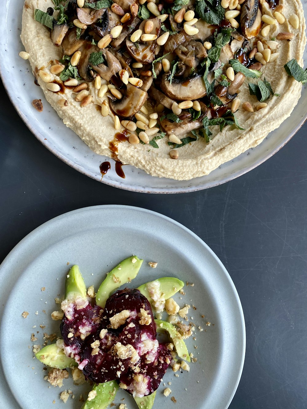 two plates of food on a table next to each other