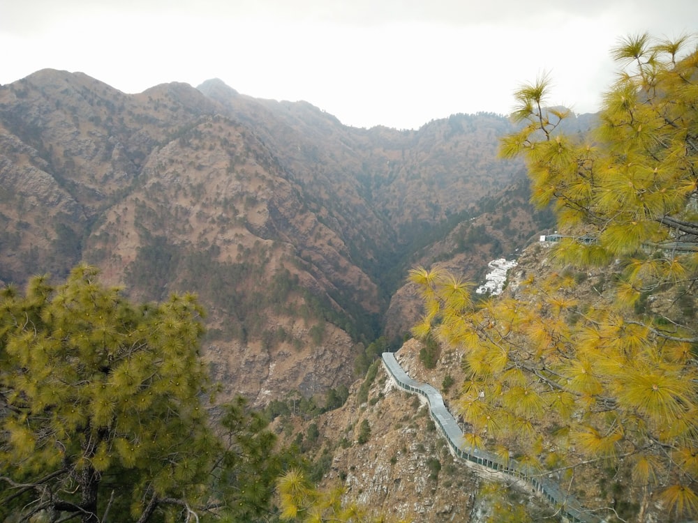 a scenic view of a winding road in the mountains