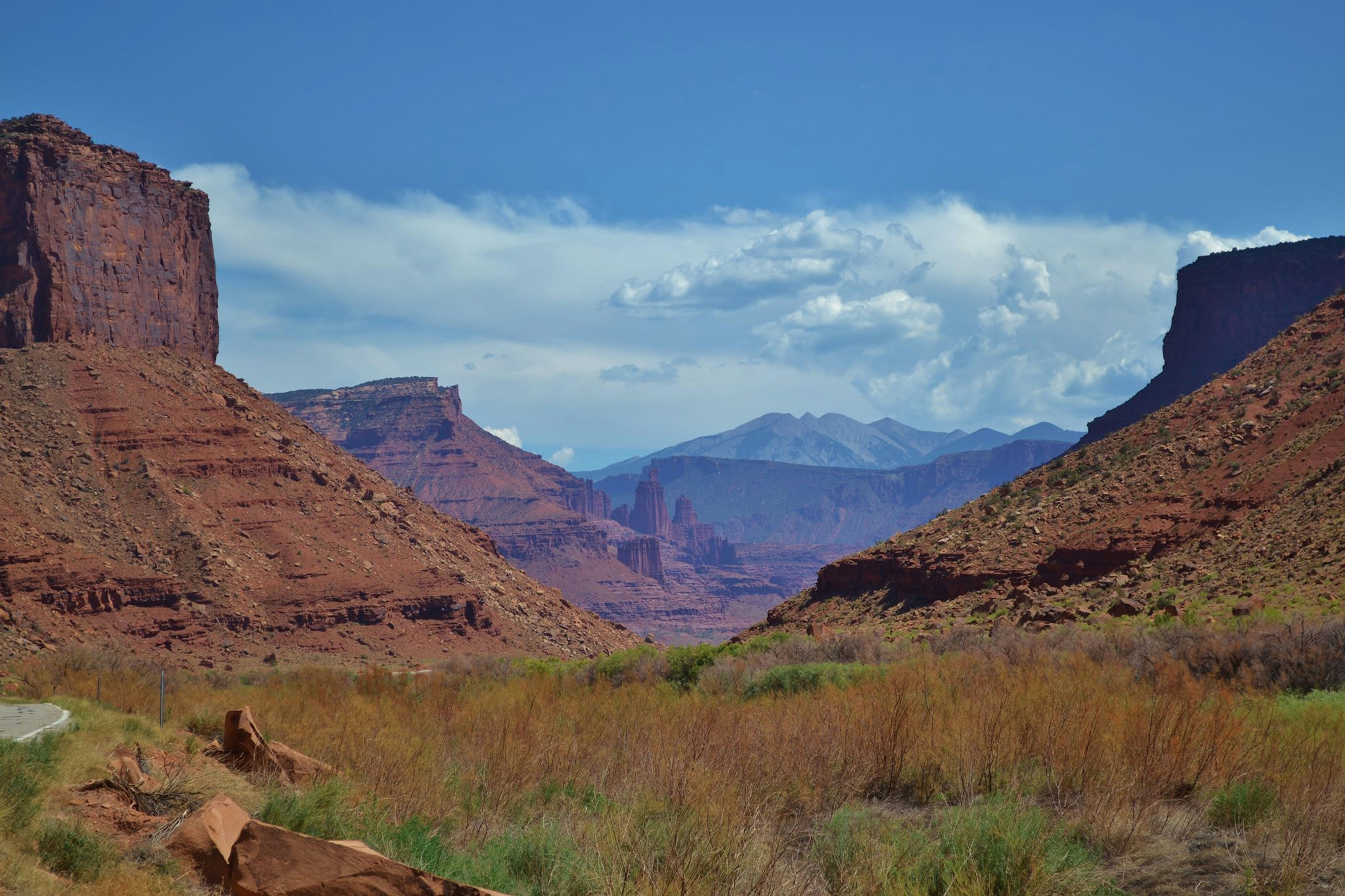 a scenic view of a mountain range with a river in the foreground, Had it not been for road construction, I