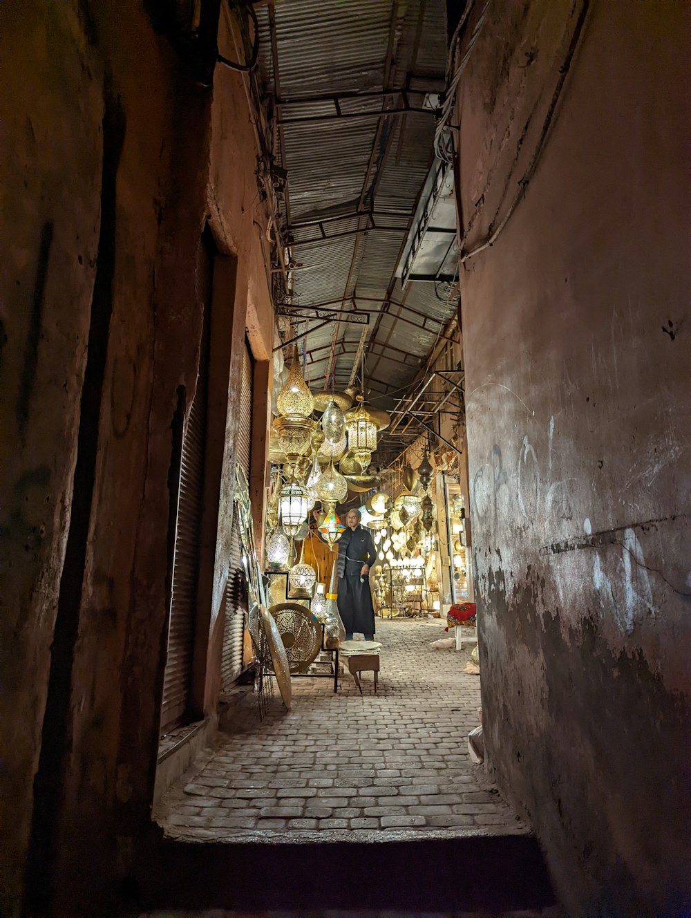a man standing in a narrow alley way