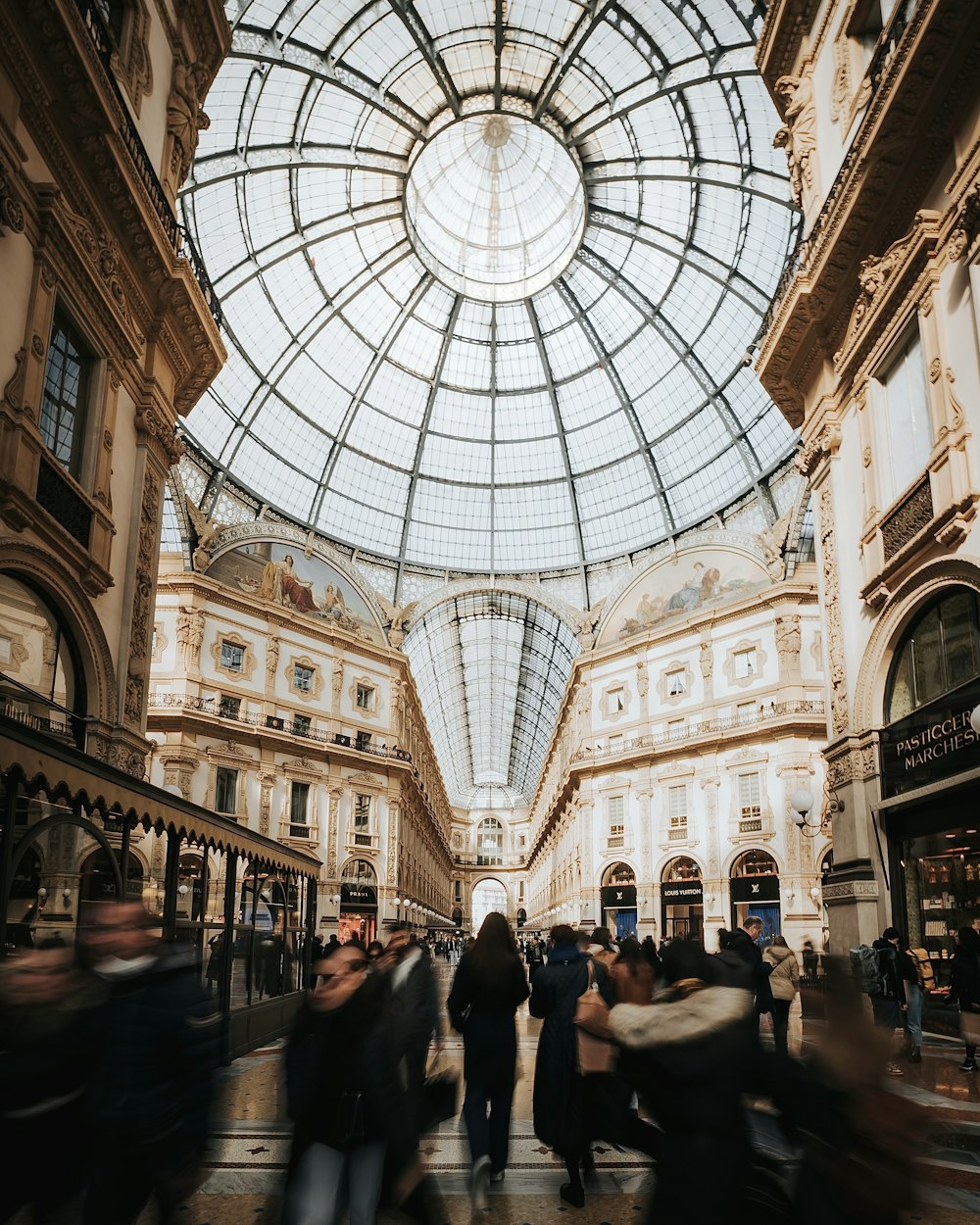 a group of people walking through a shopping mall