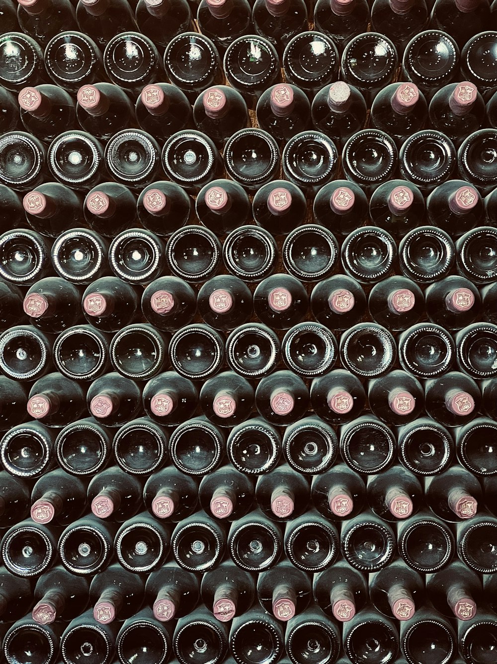 a bunch of wine bottles stacked on top of each other