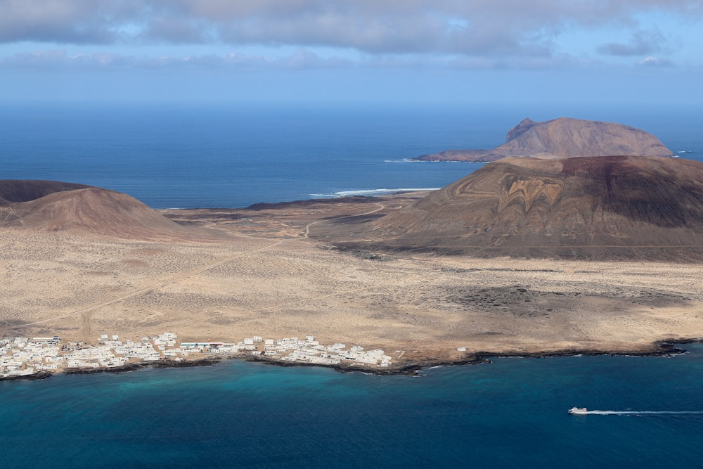 a large body of water next to a mountain