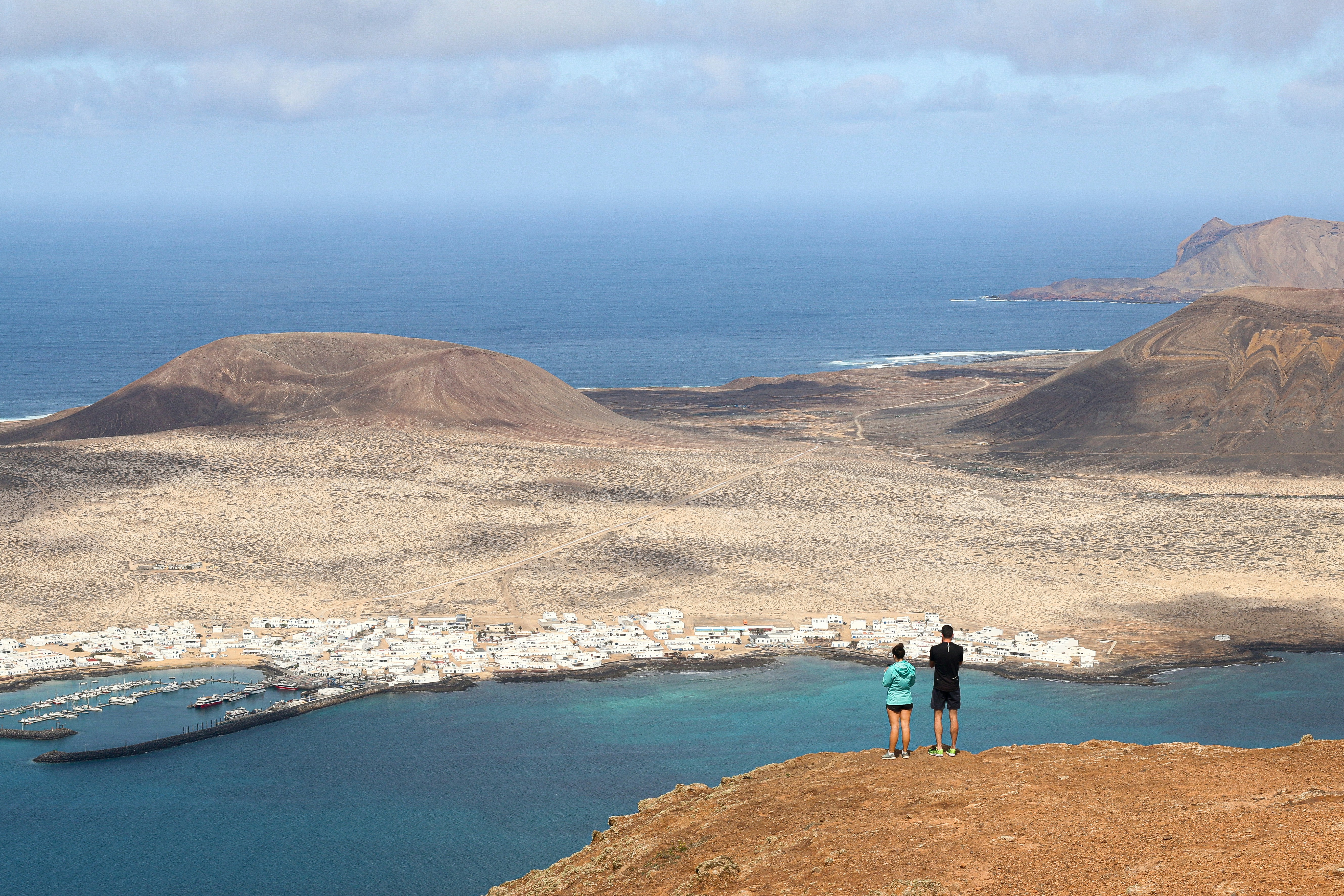 a couple of people standing on top of a hill