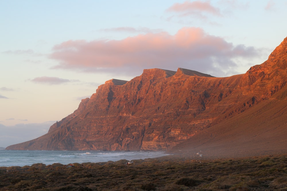 a mountain with a body of water in front of it