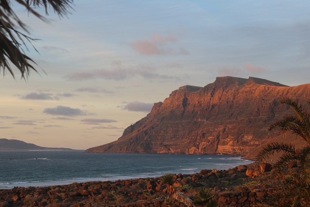 a view of a beach with a mountain in the background