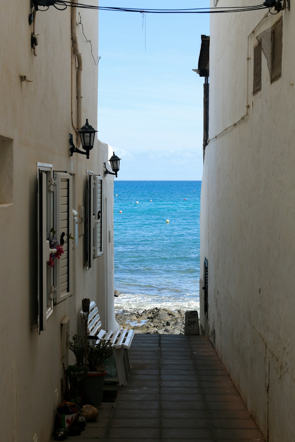 a view of the ocean from an alley way