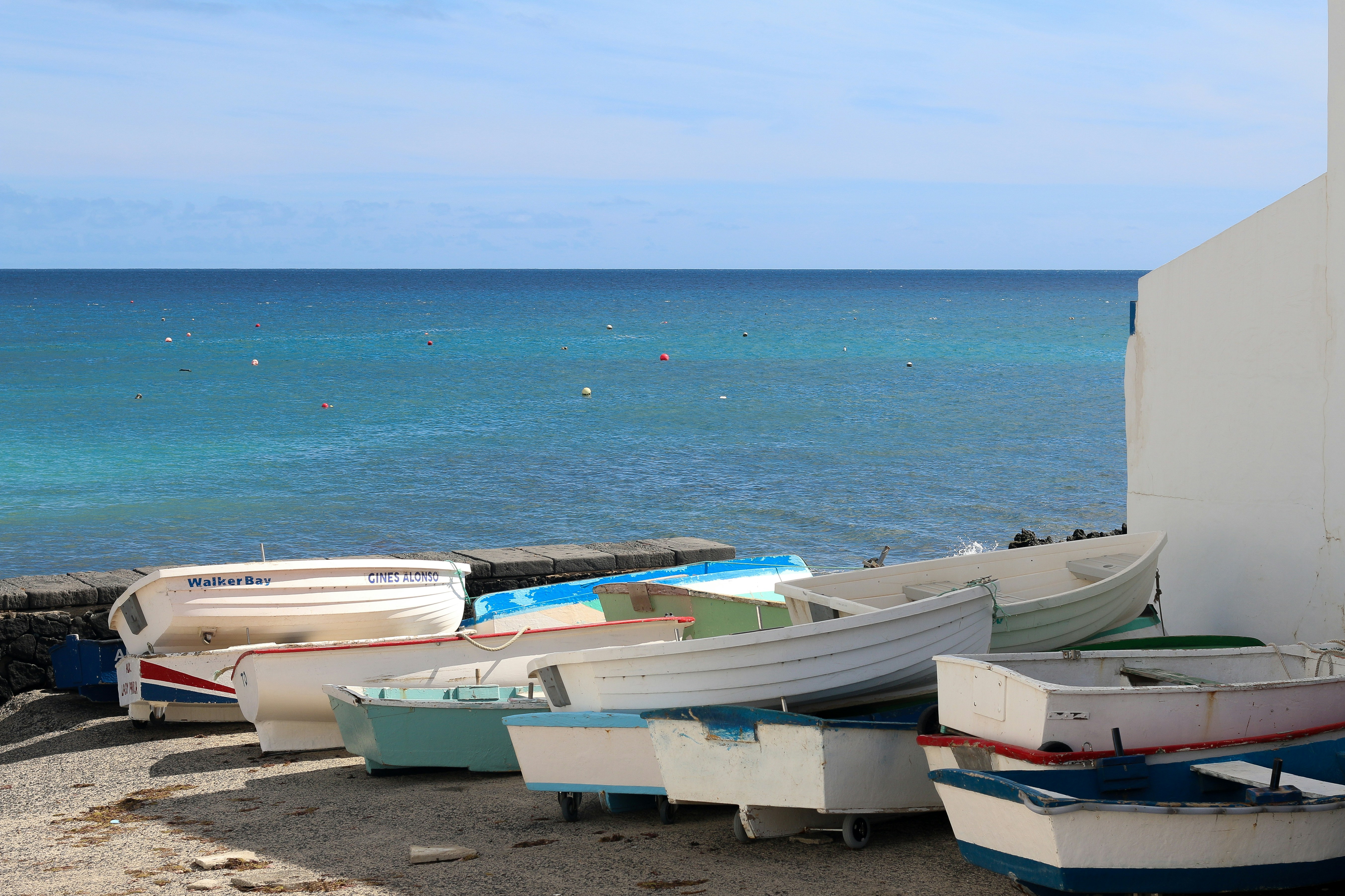 a group of boats sitting on top of a sandy beach