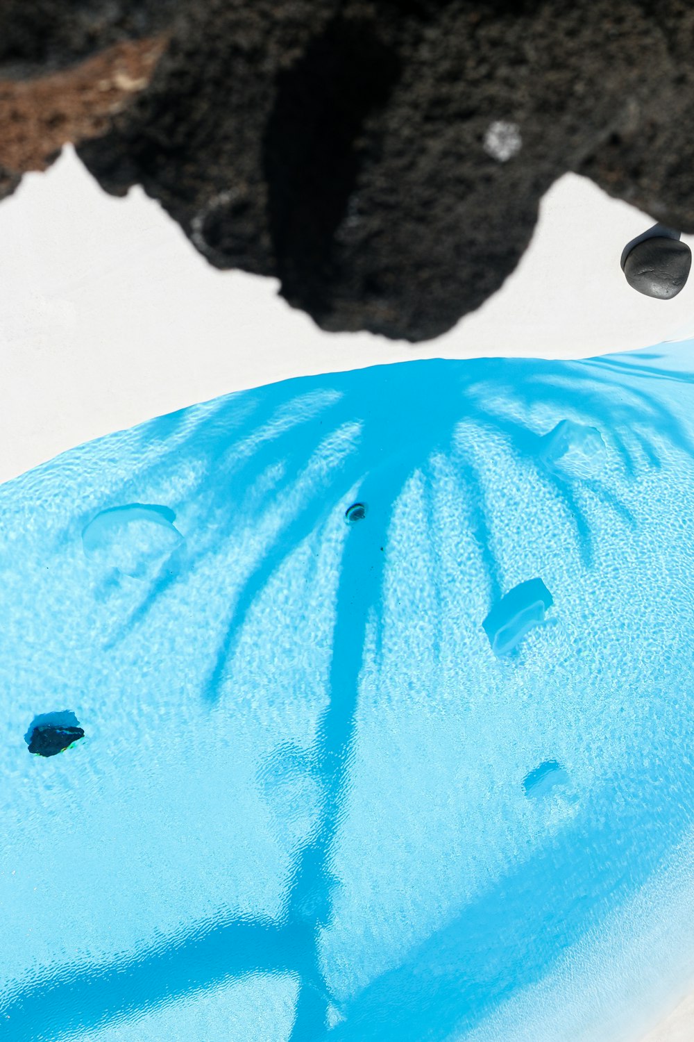 a blue umbrella sitting on top of a snow covered ground