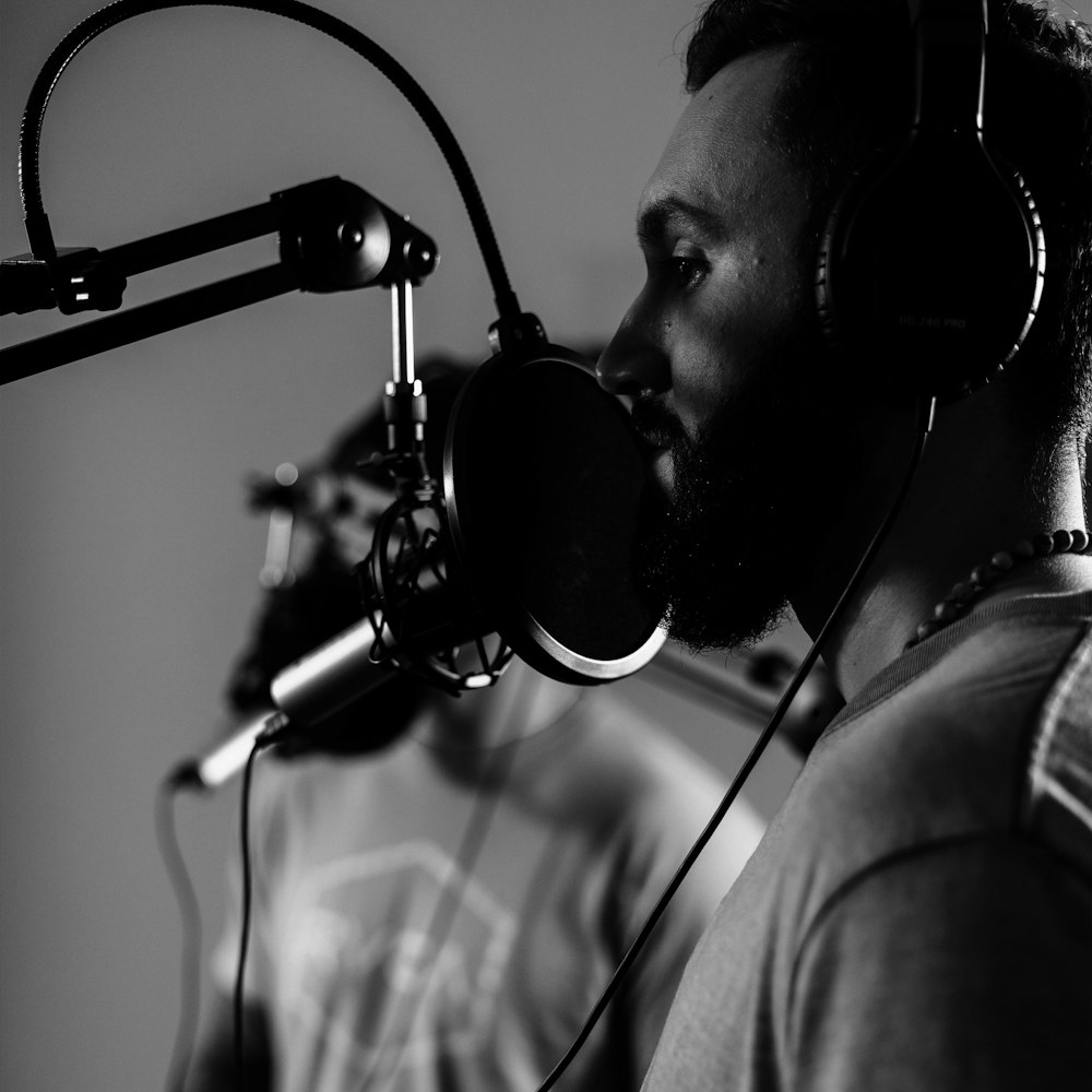 a man with headphones on in front of a microphone