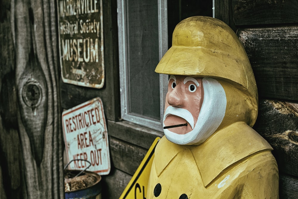 a statue of a man wearing a yellow raincoat