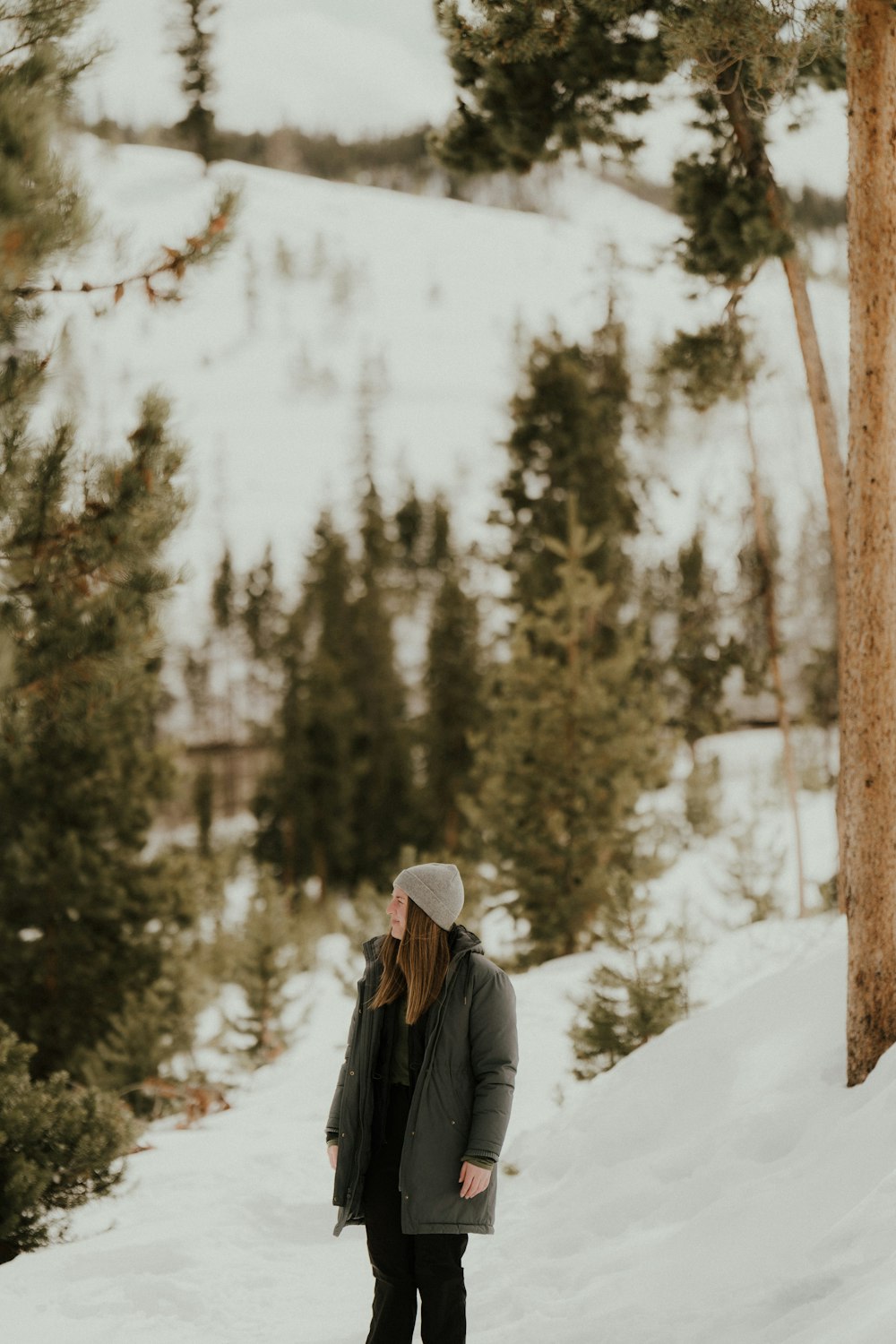 a person standing on top of a snow covered slope