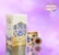A saffron packaging design featuring a large rectangular box and a smaller round container. The background is a soft gradient of pinks and purples. The packaging is adorned with floral imagery and intricate geometric patterns in shades of blue and gold. The brand name 'ATIGH SAFFRON' is prominently displayed along with a decorative logo.