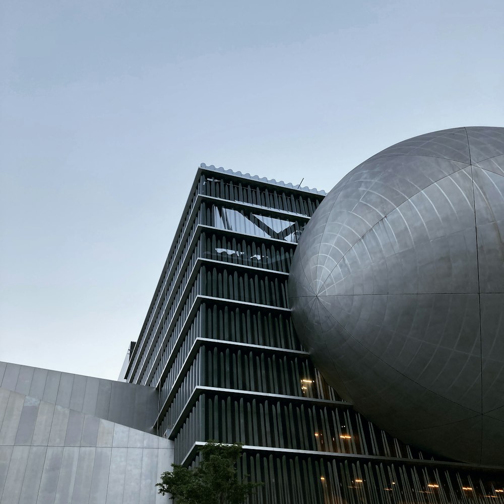 a tall building with a large metal ball on top of it