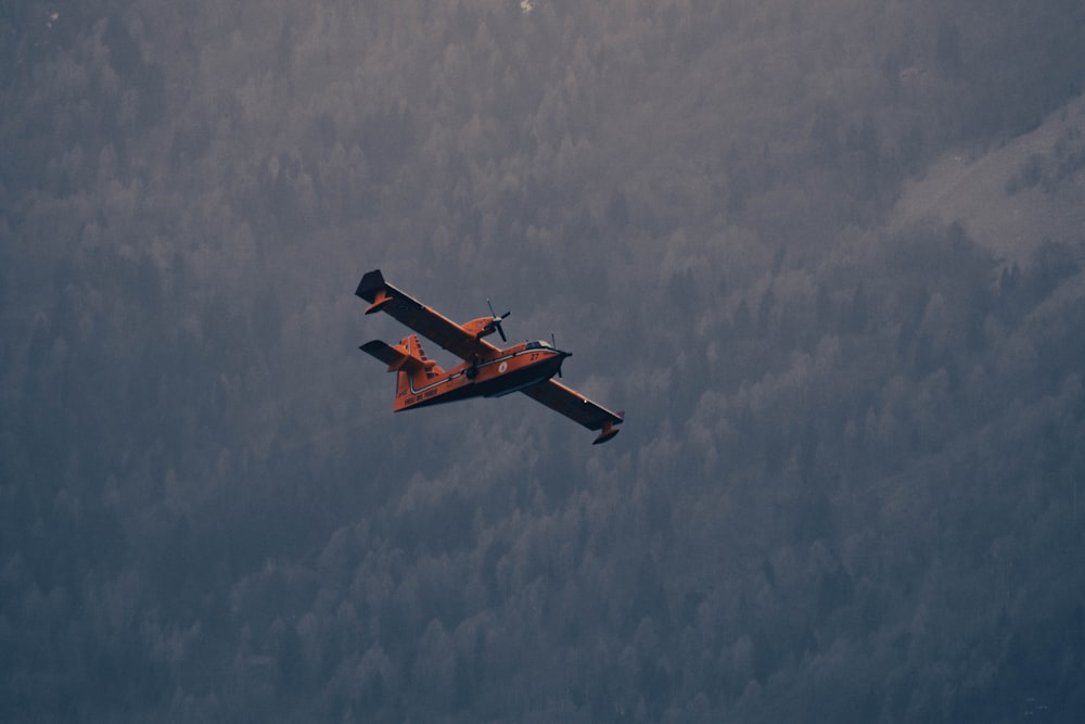 an airplane is flying in the sky above the clouds