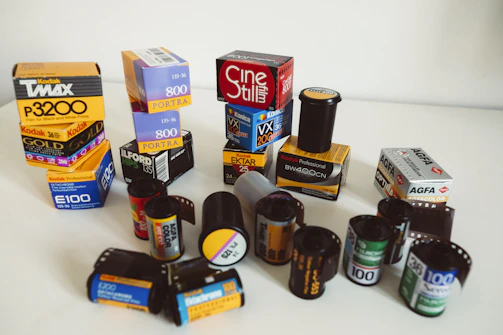 Minimalist display of ink cartridges, micro SD cards, and film rolls together, highlighting product variety.
