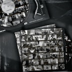 A vintage-style image features a vinyl record player with a record labeled 'Ricky Rique - Love Gun' on the turntable. Nearby, there are film contact sheets displaying black-and-white images of people, including individuals in suits and hats, evoking a classic or retro feel.
