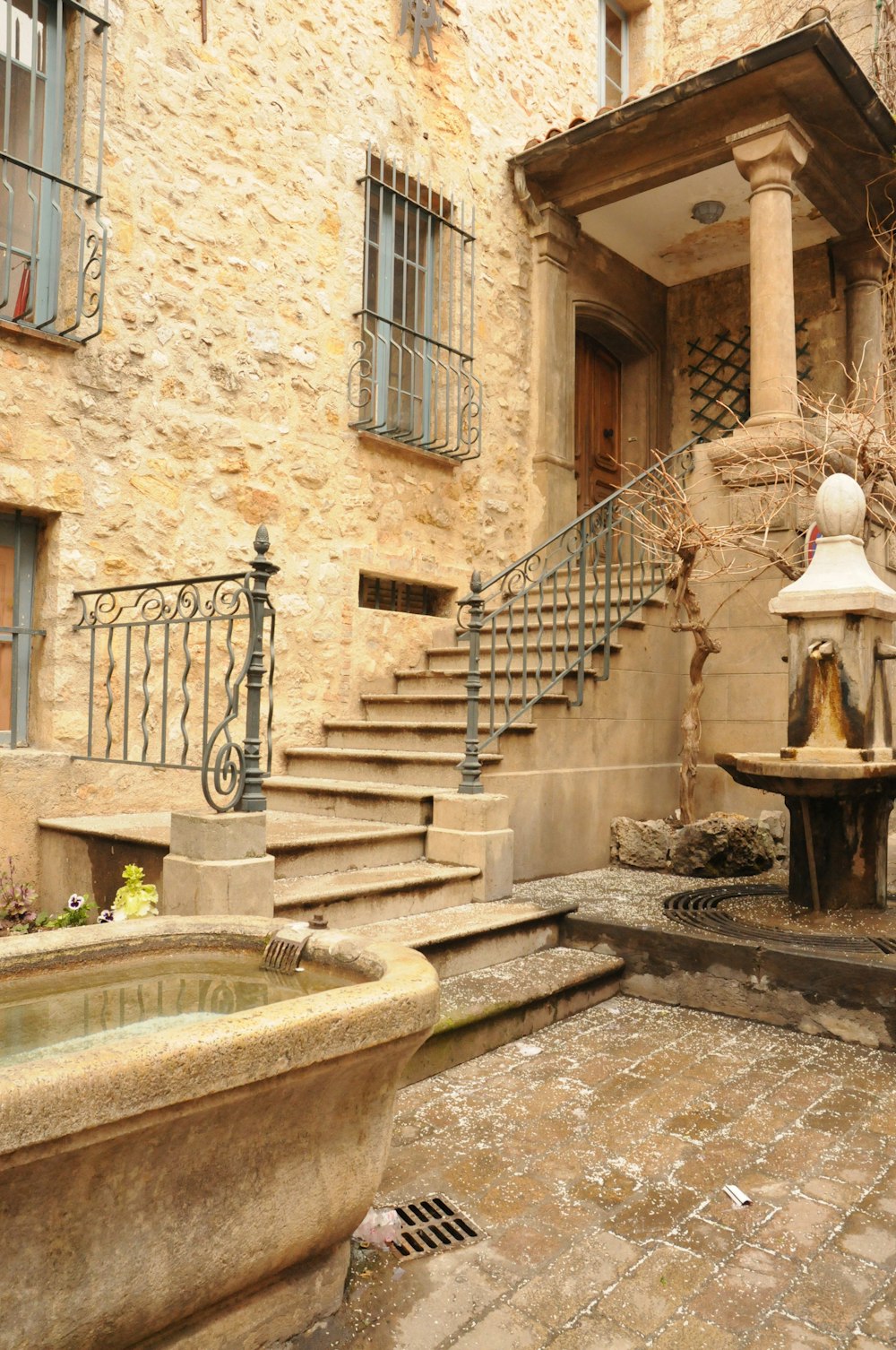 a stone building with a fountain in front of it