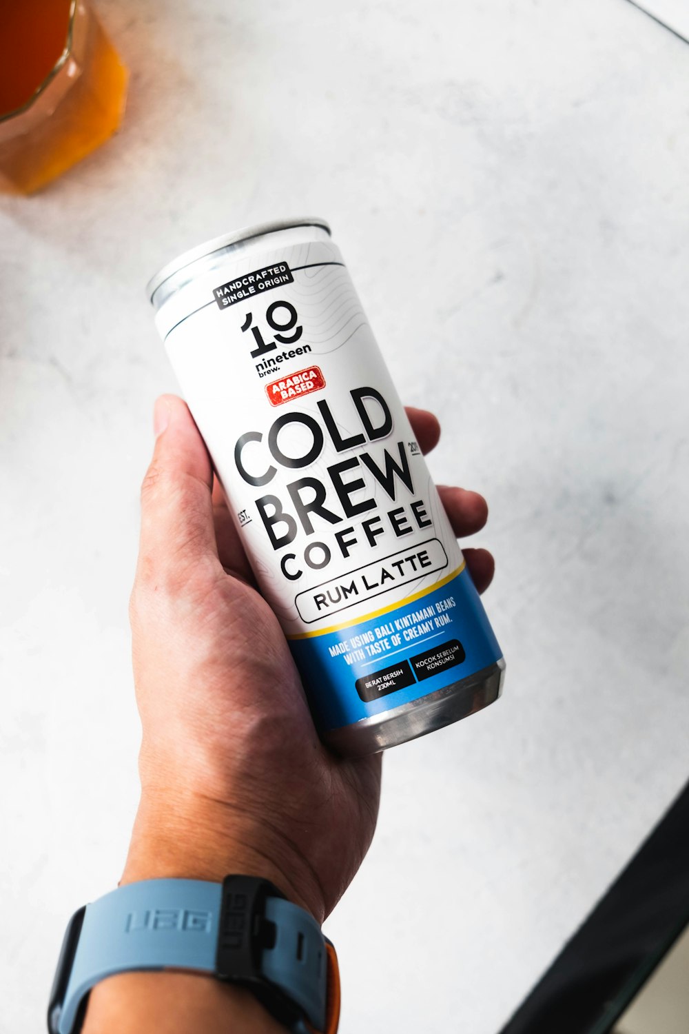 a person holding a can of cold brew coffee