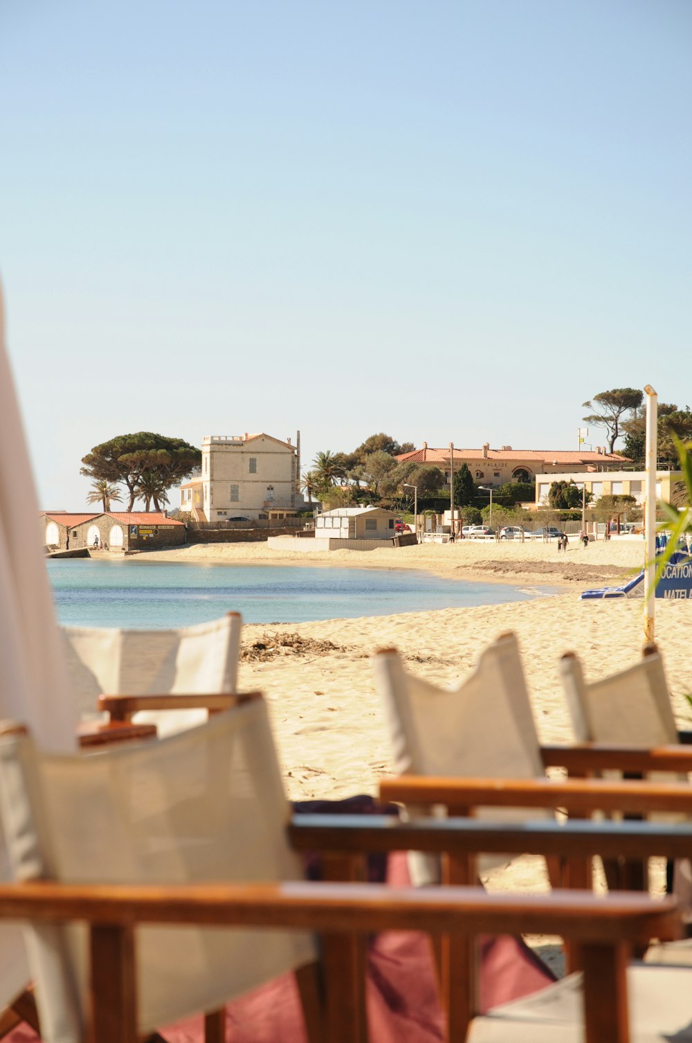 a row of beach chairs sitting on top of a sandy beach