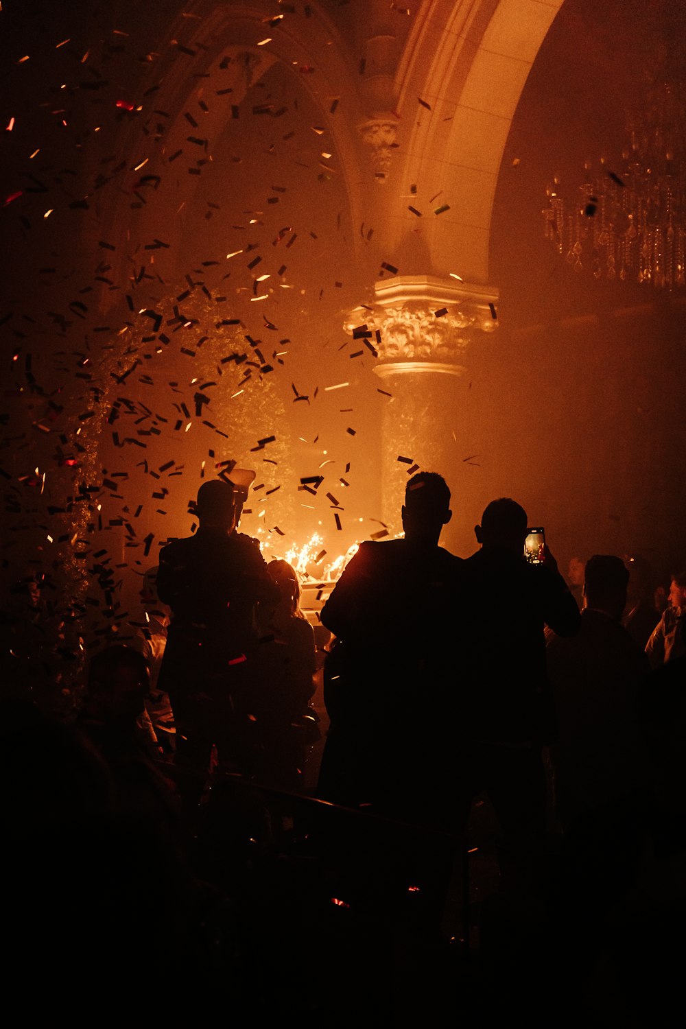 a group of people standing in front of a fire