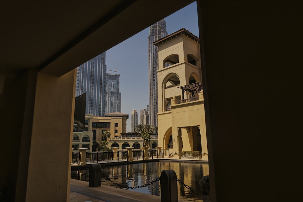 a clock tower towering over a city next to a body of water