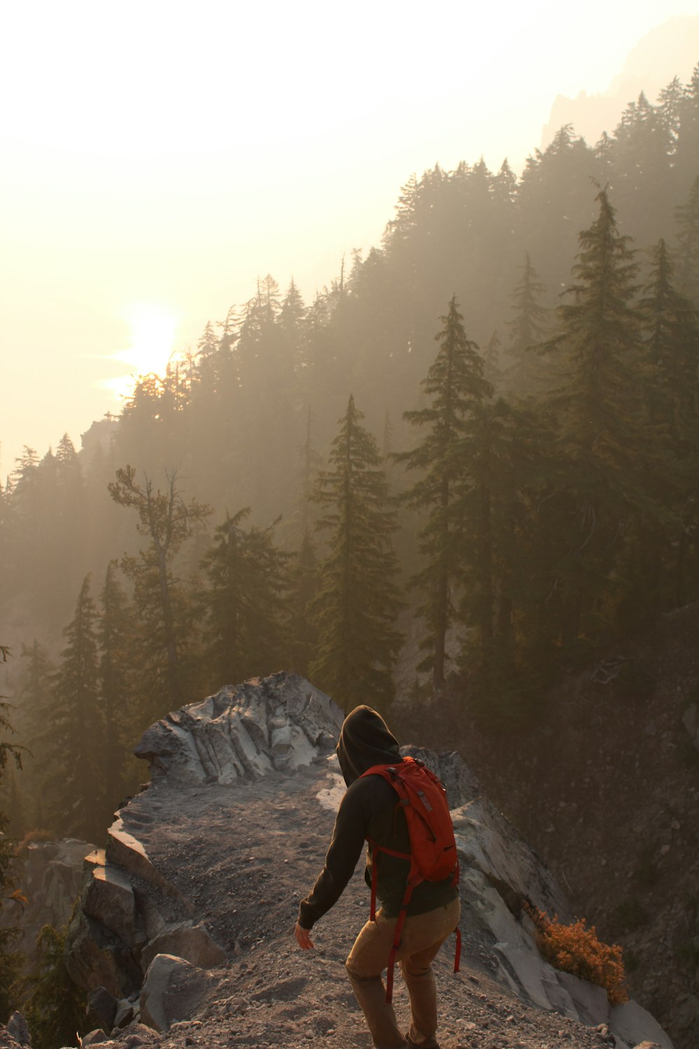 a person with a backpack walking up a hill