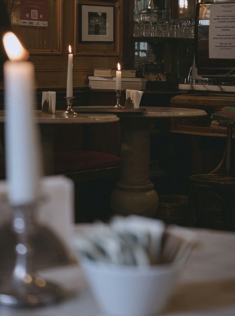 a candle is lit in a dimly lit restaurant