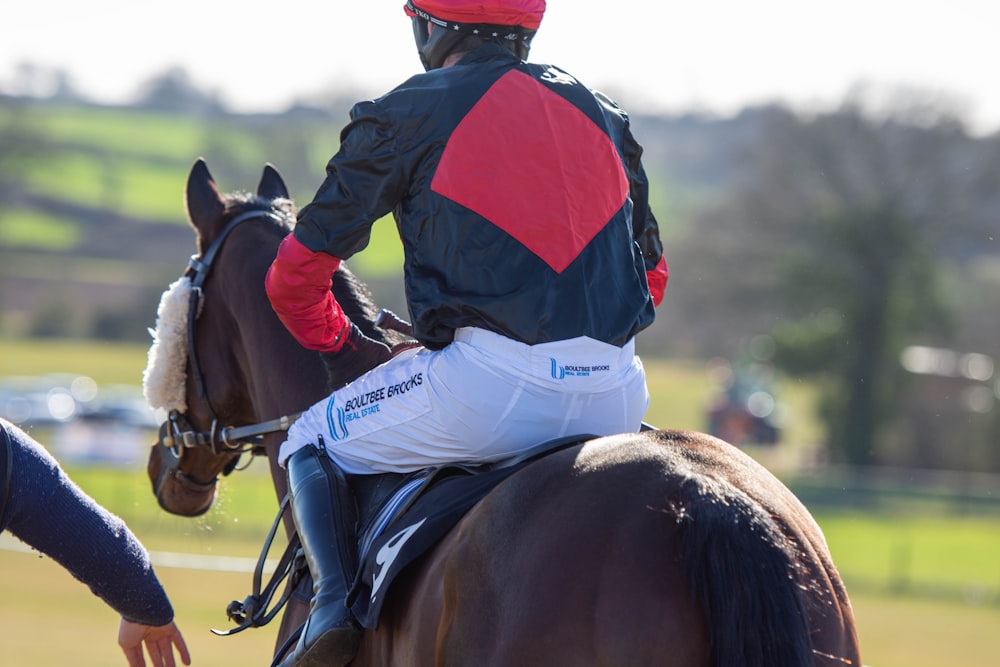 a jockey is riding a horse in a field