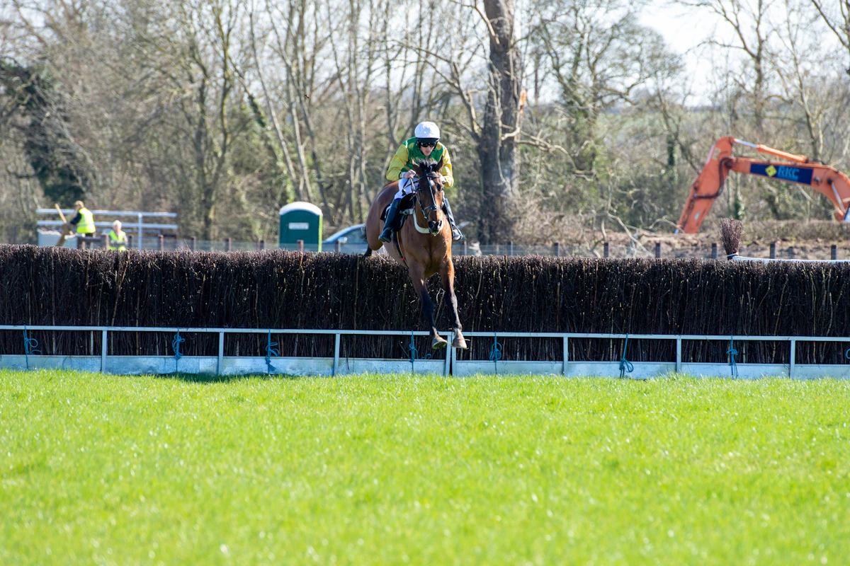 Jockey on a horse rounding a turn on a dirt track