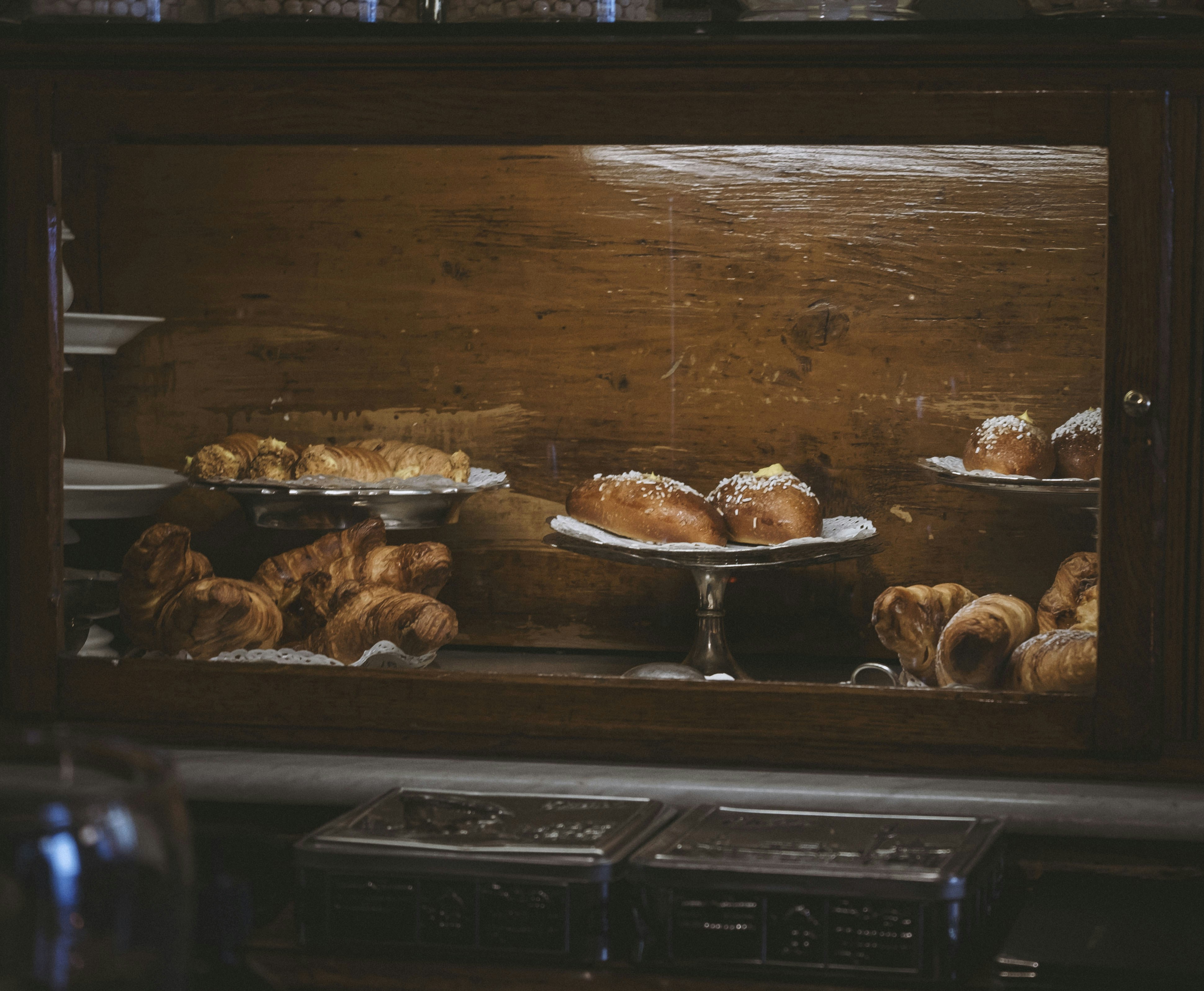 a display case filled with lots of pastries, 