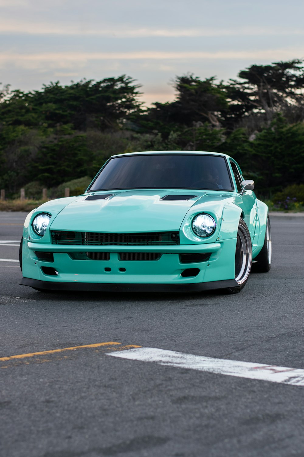 a blue sports car parked in a parking lot