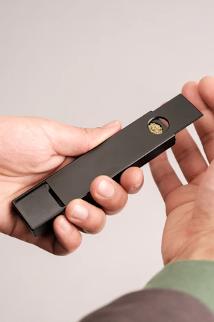 A customer holding a 2cmc product, showcasing its compact and elegant design.
